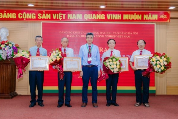 Đồng chí Phạm Văn Cường trang trọng gắn Huy hiệu Đảng, trao Quyết định và tặng hoa chúc mừng các đồng chí vinh dự được nhận Huy hiệu Đảng